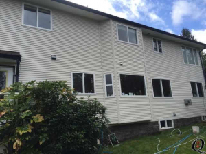 2 story home with vinyl siding windows getting washed